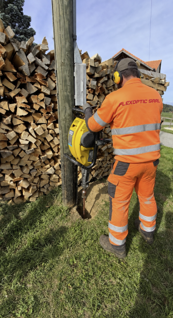 Technicien FlexOptic réalisant une mise à terre près d’un poteau